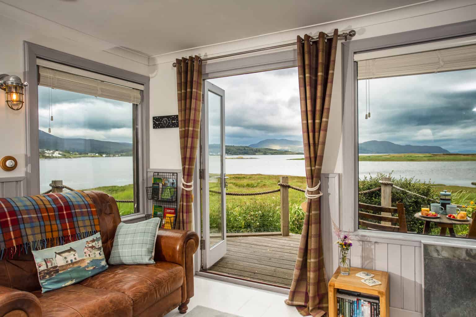 72 WatersideCabinLoungeWidejpg Waterside Cabin lounge, with French doors open onto the deck and Broadford Bay